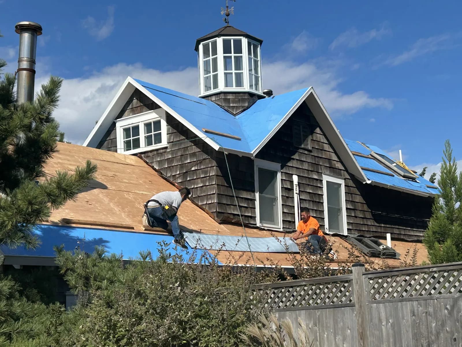 Roofers installing a cedar shake roof on a Ship Bottom home