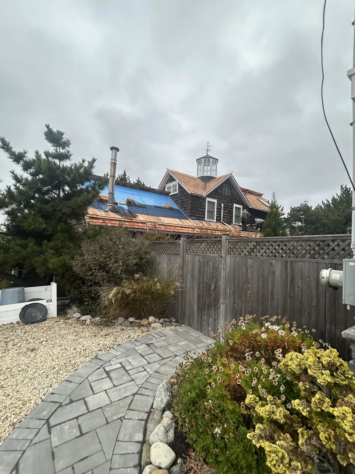 Wide view of cedar shake roofing work in progress in Ship Bottom